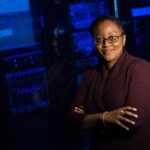 Black female outside a server rack